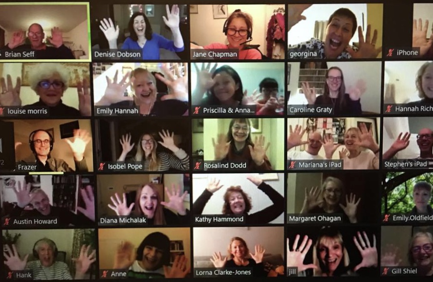 Screenshot showing lots of Songworks choir members waving on Zoom